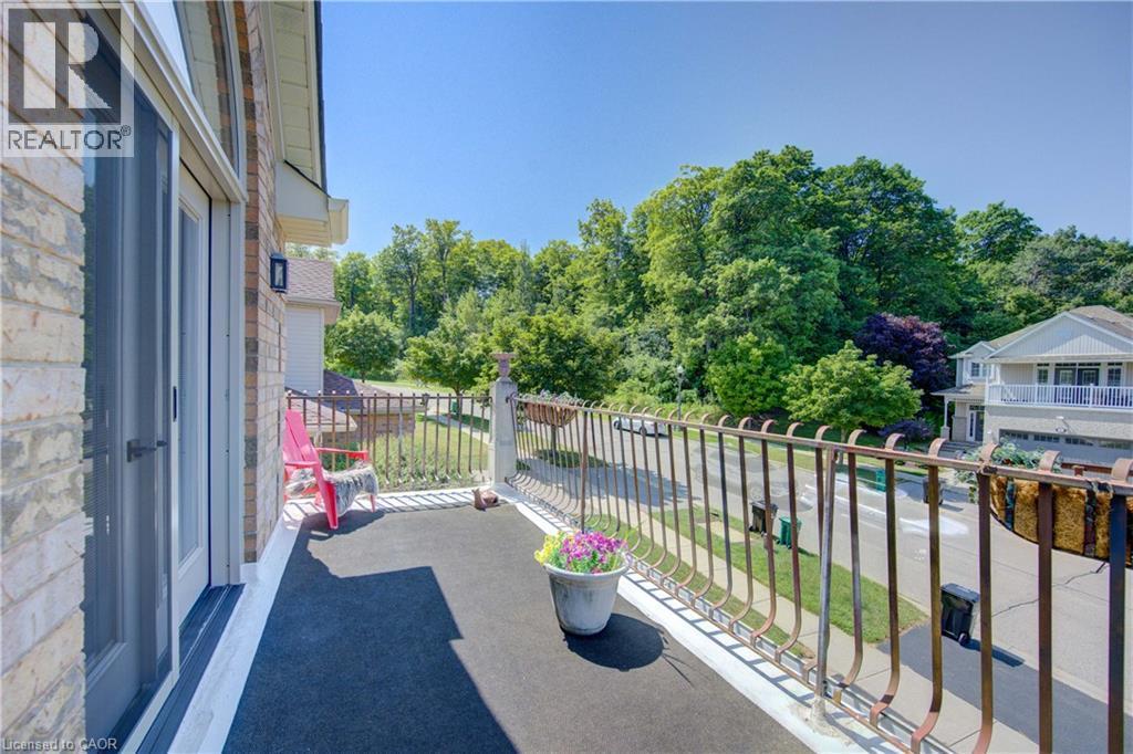 Exterior balcony featuring brick siding and a decorative metal railing - 74 Forest Edge Trail, Kitchener, ON