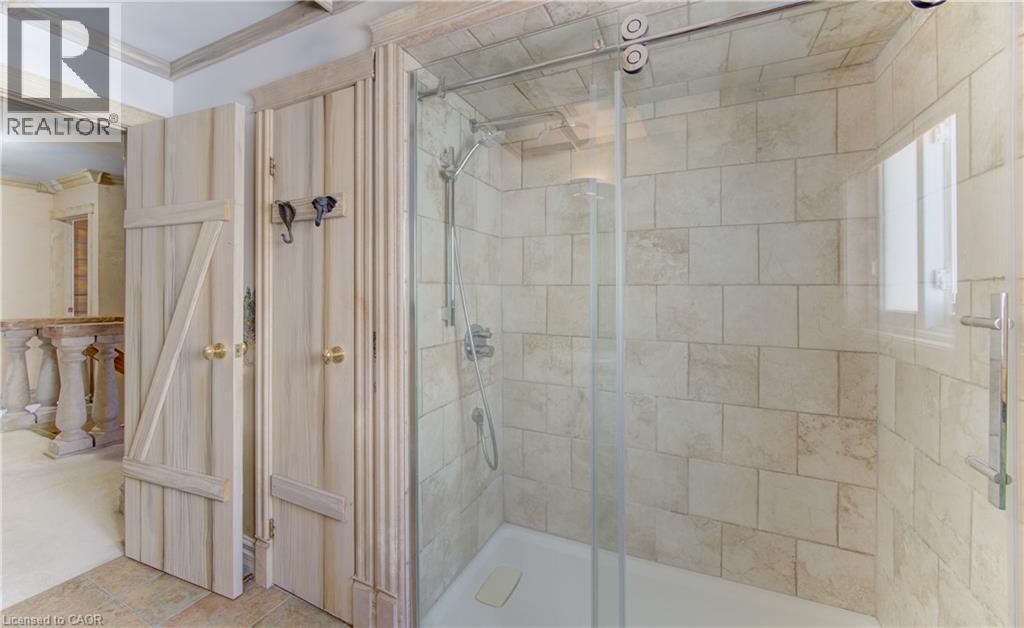 Glass-enclosed shower featuring subway tile surround, polished chrome fixtures, and a sliding door - 74 Forest Edge Trail, Kitchener, ON
