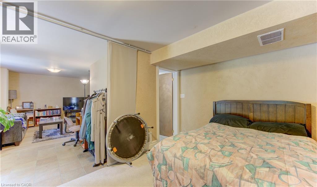 Recessed lighting illuminates the tiled flooring and neutral-toned walls throughout this adaptable interior space - 74 Forest Edge Trail, Kitchener, ON