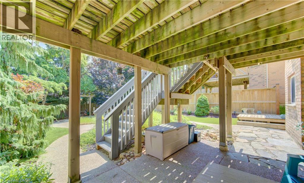 Covered patio area featuring a concrete slab and stone patio - 74 Forest Edge Trail, Kitchener, ON
