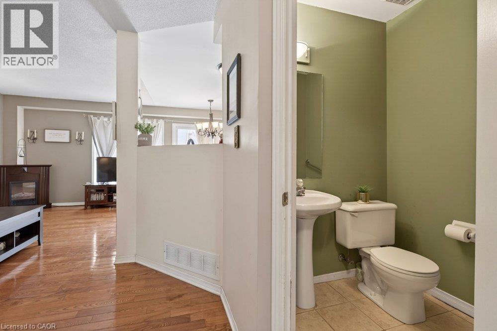 Powder room with pedestal sink and tiled flooring - 10 Cadham Boulevard Unit# 29, Hamilton, ON - Indoor Photo Showing Bathroom