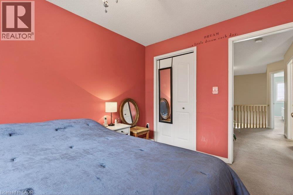 White bi-fold closet doors with black trim - 10 Cadham Boulevard Unit# 29, Hamilton, ON - Indoor Photo Showing Bedroom
