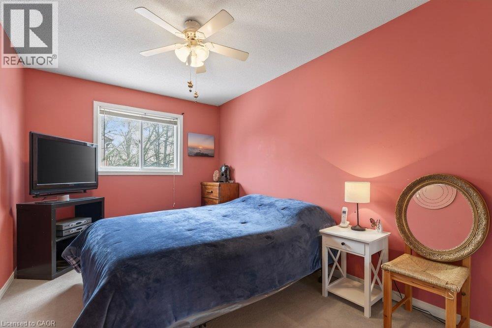 Window with natural light, ceiling fan, carpeted flooring, and painted walls - 10 Cadham Boulevard Unit# 29, Hamilton, ON - Indoor Photo Showing Bedroom