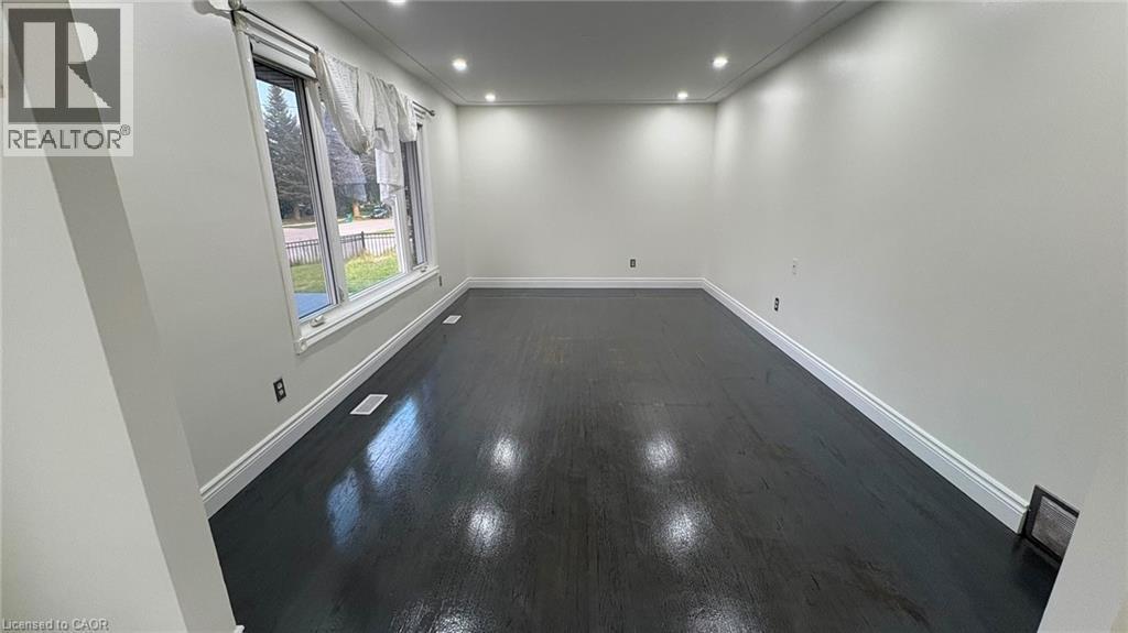 Hardwood flooring, recessed lighting, white trim, and a large window - 161 Kipling Avenue, Kitchener, ON - Indoor Photo Showing Other Room