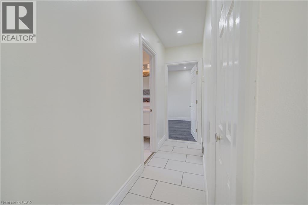 Corridor featuring rectangular tile flooring, recessed lighting, and white paneled doors - 161 Kipling Avenue, Kitchener, ON - Indoor Photo Showing Other Room
