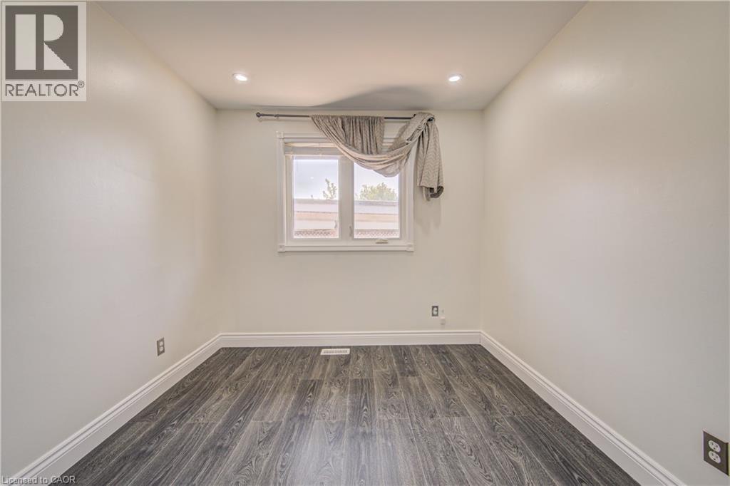 Recessed ceiling lighting, wood-finish flooring, white walls, and a window with white trim - 161 Kipling Avenue, Kitchener, ON - Indoor Photo Showing Other Room