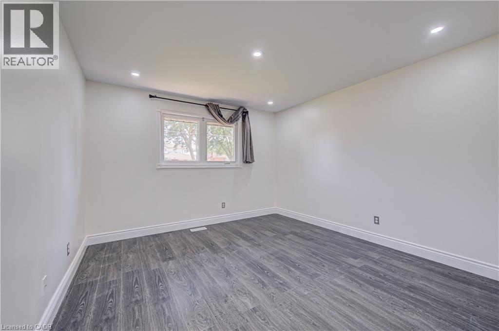 Recessed lighting, wood-finish flooring, white trim, and a window with a white frame - 161 Kipling Avenue, Kitchener, ON - Indoor Photo Showing Other Room