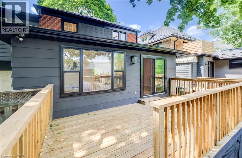 Expansive wooden deck with natural wood railing - 34 Moore Avenue N, Waterloo, ON - Outdoor With Deck Patio Veranda With Exterior