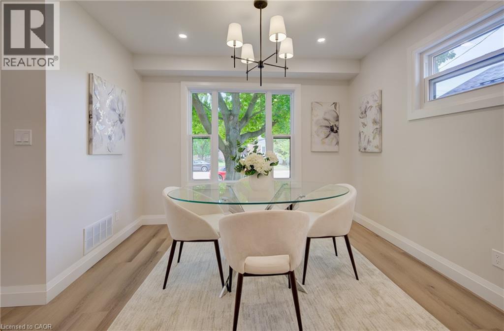 Recessed lighting, wood-finish flooring, white trim, and a multi-light chandelier - 34 Moore Avenue N, Waterloo, ON - Indoor Photo Showing Dining Room