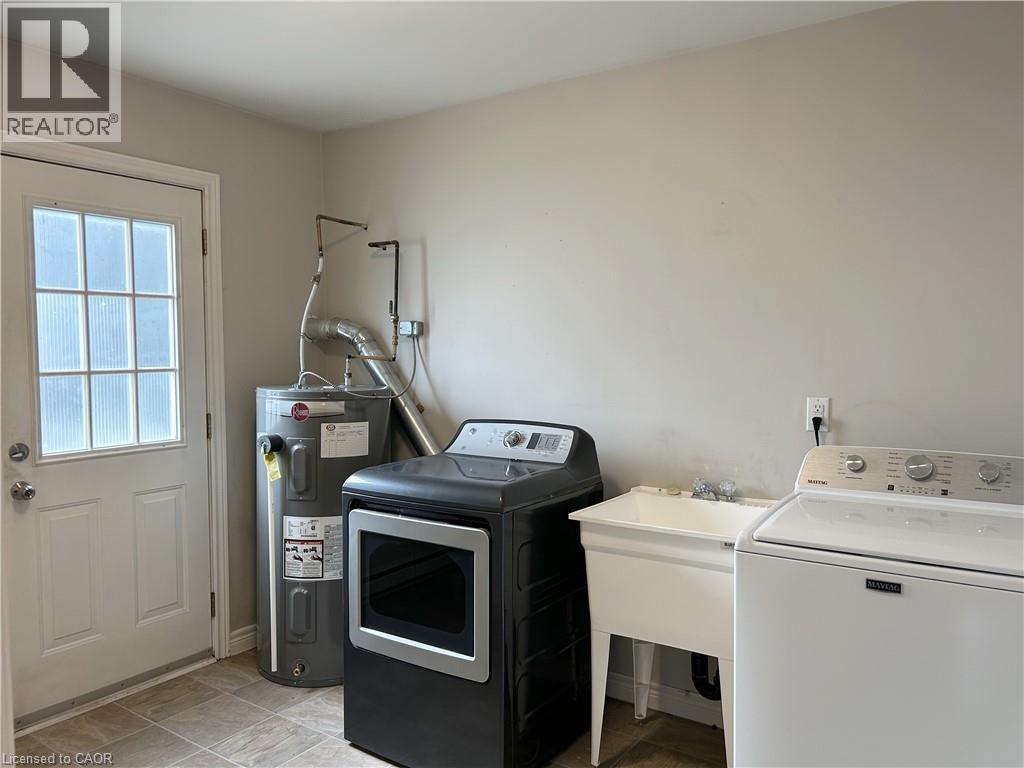 Laundry room with side access to outside - 15 Montclair Crescent Unit# 2, Simcoe, ON - Indoor Photo Showing Laundry Room