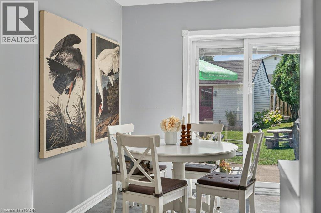 Sliding glass door, baseboard trim, and gray wall paint - 60 Elford Crescent, Hamilton, ON - Indoor Photo Showing Dining Room