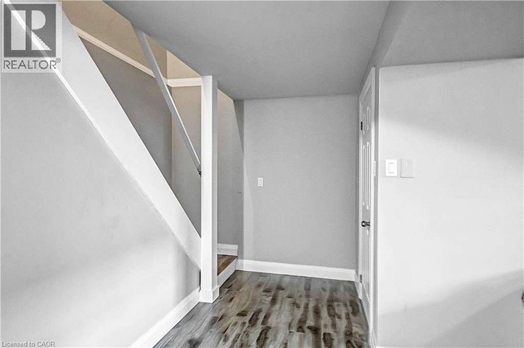 Hallway with stairway and light wood-style flooring - 8 Brantdale Avenue, Hamilton, ON - Indoor Photo Showing Other Room