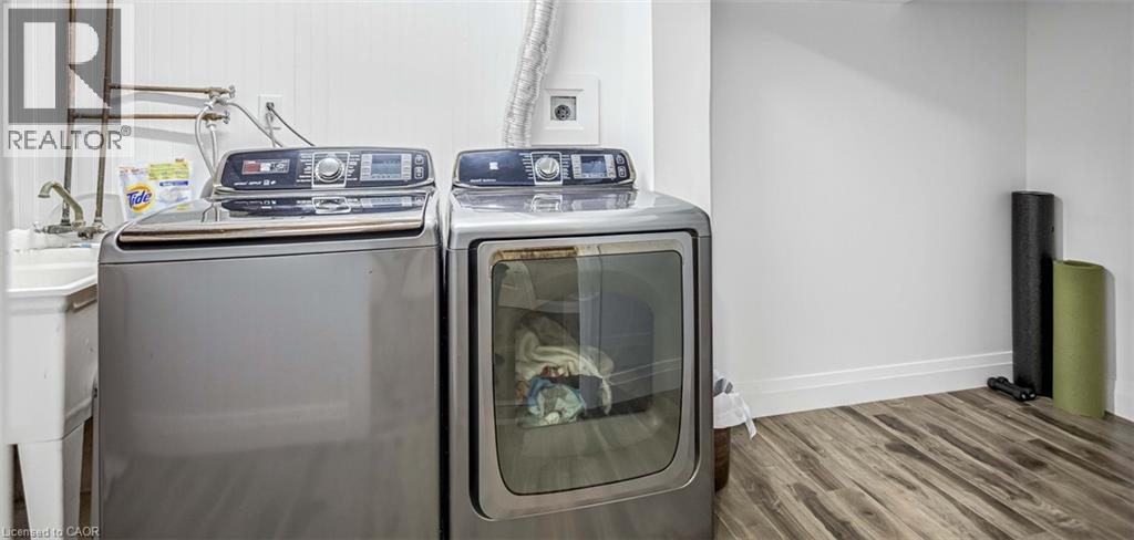 Laundry room with wood finished floors and separate washer and dryer - 8 Brantdale Avenue, Hamilton, ON - Indoor Photo Showing Laundry Room