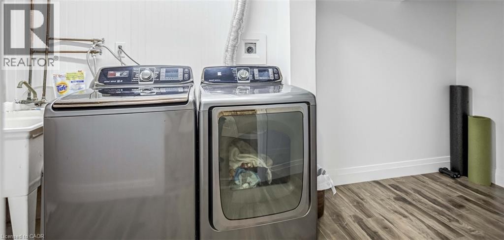 Laundry room with wood finished floors and separate washer and dryer - 8 Brantdale Avenue, Hamilton, ON - Indoor Photo Showing Laundry Room