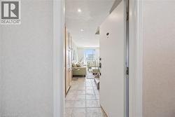 Entryway featuring tile flooring, recessed lighting, and built-in wood-finish cabinetry - 
