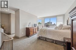 Carpeted bedroom with expansive windows, recessed lighting, and neutral wall tones - 