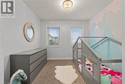 Bedroom featuring light carpet and a textured ceiling - 
