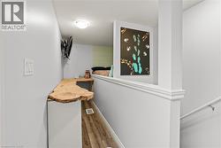 Hall featuring dark wood-style floors and baseboards - 