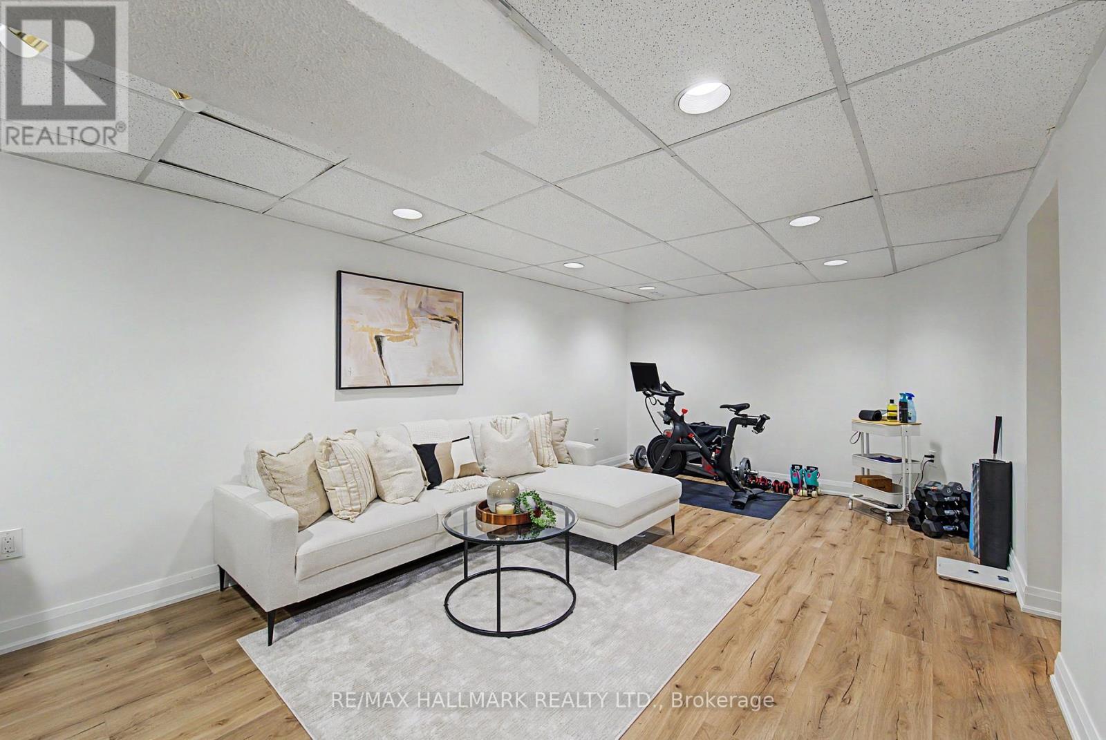 Large Rec Room vinyl floors bsmt - 117 Clappison Boulevard, Toronto, ON - Indoor Photo Showing Living Room