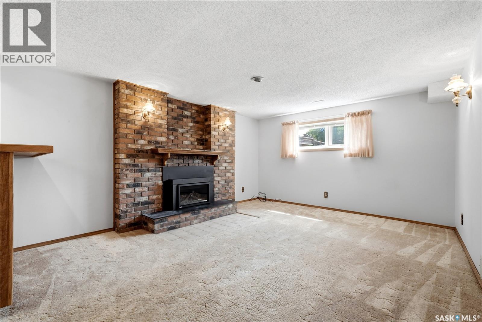 39 Hayes Crescent, Regina, SK - Indoor Photo Showing Living Room With Fireplace