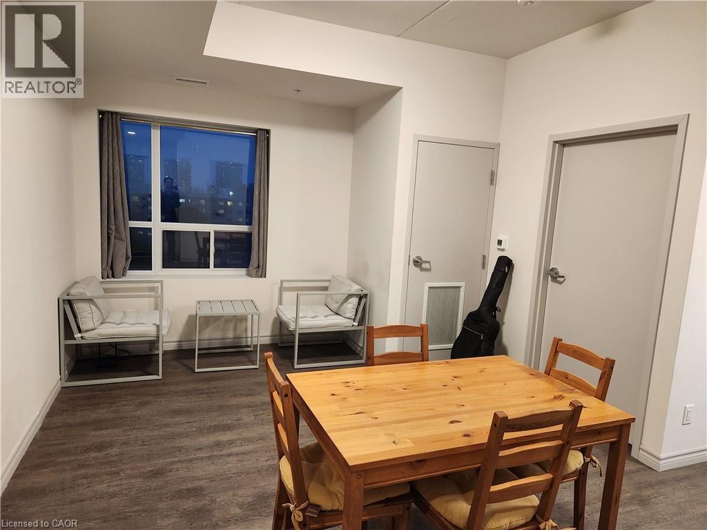 Dining room featuring dark wood finished floors and baseboards - 269 Sunview Street Unit# 607, Waterloo, ON - Indoor