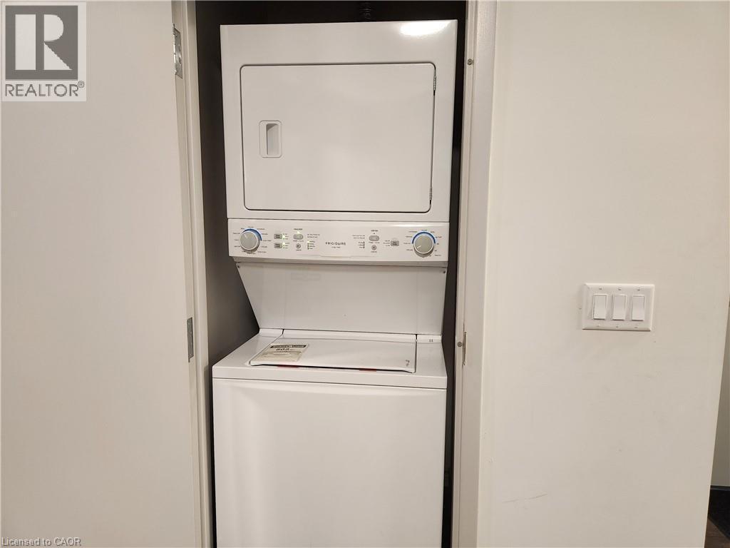 Clothes washing area with laundry area and stacked washer / drying machine - 269 Sunview Street Unit# 607, Waterloo, ON - Indoor Photo Showing Laundry Room