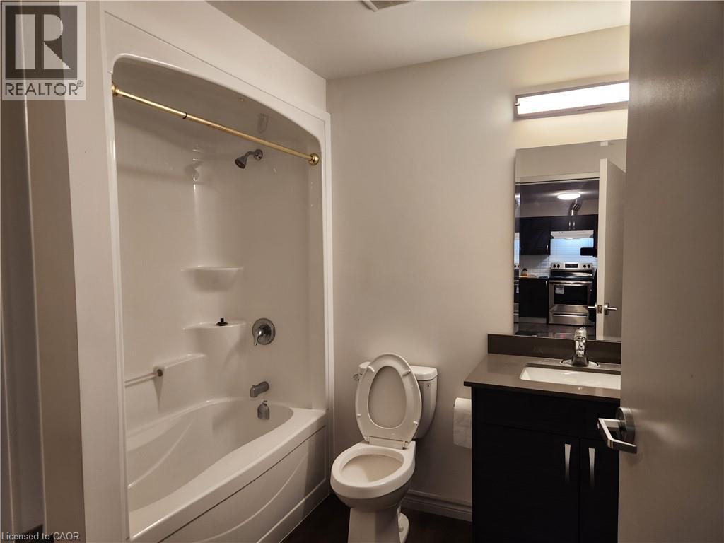 Full bathroom featuring toilet, washtub / shower combination, and vanity - 269 Sunview Street Unit# 607, Waterloo, ON - Indoor Photo Showing Bathroom