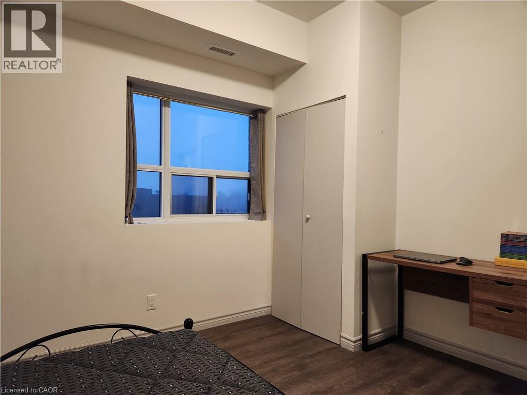 Furnished bedroom featuring visible vents and dark wood finished floors - 269 Sunview Street Unit# 607, Waterloo, ON - Indoor