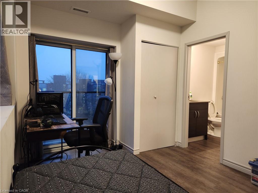 Furnished bedroom with wood finished floors and visible vents - 269 Sunview Street Unit# 607, Waterloo, ON - Indoor Photo Showing Other Room