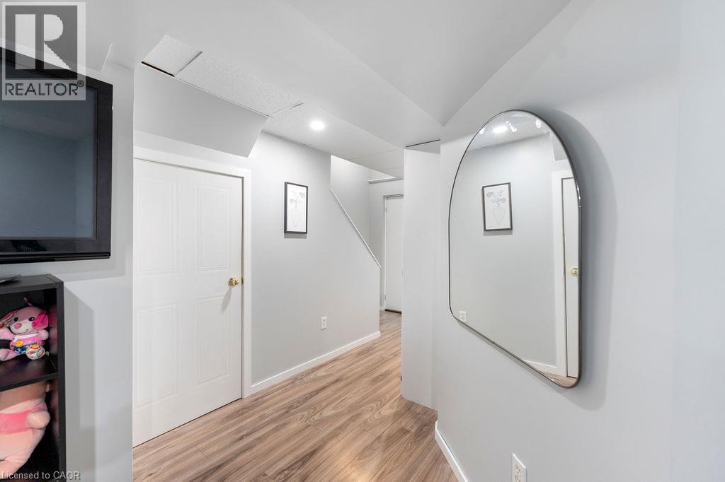 Hallway featuring wood-finish flooring, light grey walls, white trim, and recessed lighting - 33 Remple Court, Cambridge, ON - Indoor Photo Showing Other Room
