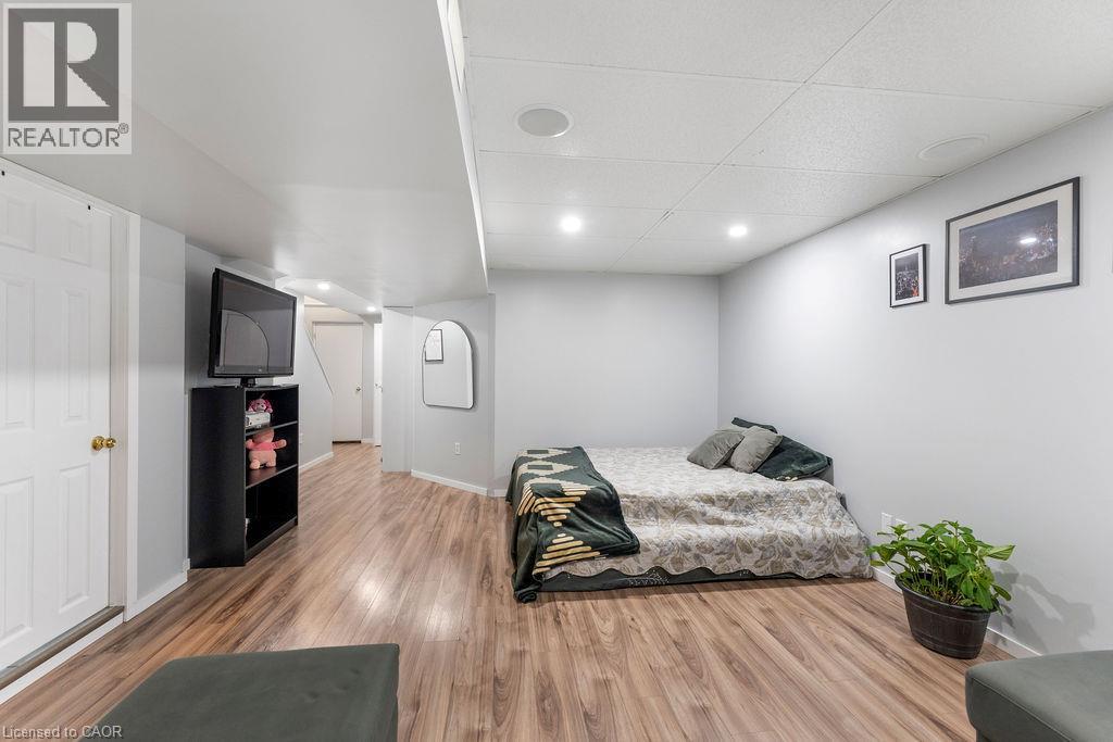 Finished lower level featuring wood-finish flooring, recessed lighting, and a drop ceiling - 33 Remple Court, Cambridge, ON - Indoor