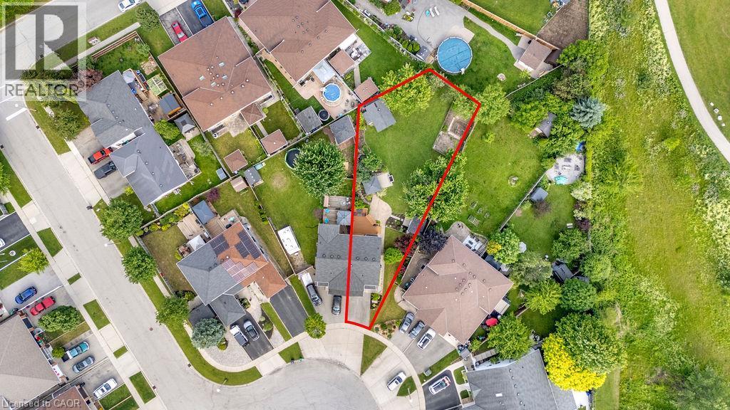 Generous lot outlined in red, featuring a residential property with a multi-car driveway, and a spacious backyard with mature trees - 33 Remple Court, Cambridge, ON - Other