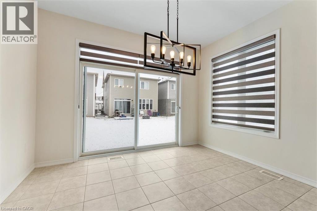 Empty room with baseboards, visible vents, a chandelier, and a wealth of natural light - 13 Steven Drive, Thorold, ON - Indoor Photo Showing Other Room