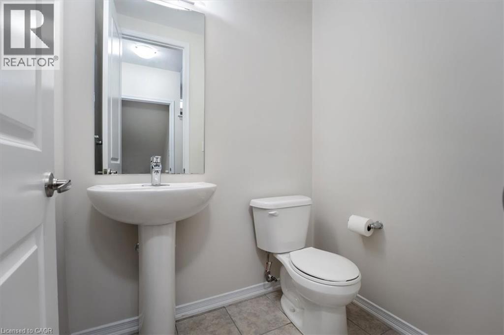 Bathroom featuring tile patterned flooring, toilet, and baseboards - 13 Steven Drive, Thorold, ON - Indoor Photo Showing Bathroom