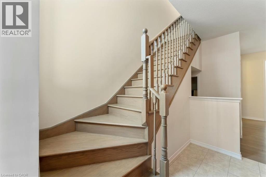 Stairway with tile patterned flooring and baseboards - 13 Steven Drive, Thorold, ON - Indoor Photo Showing Other Room