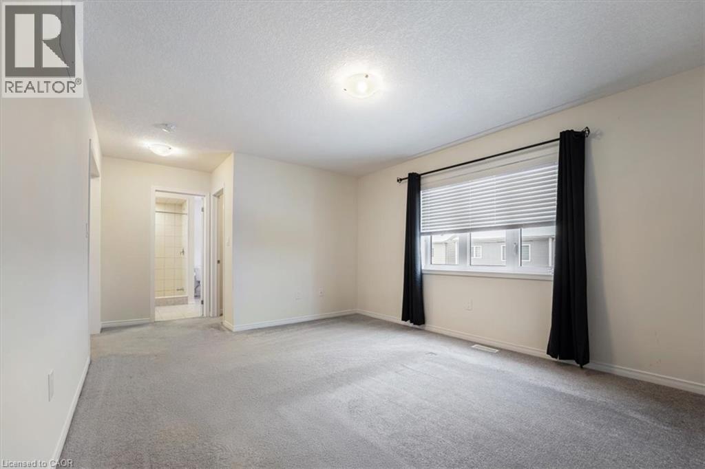 Carpeted empty room with baseboards and a textured ceiling - 13 Steven Drive, Thorold, ON - Indoor Photo Showing Other Room