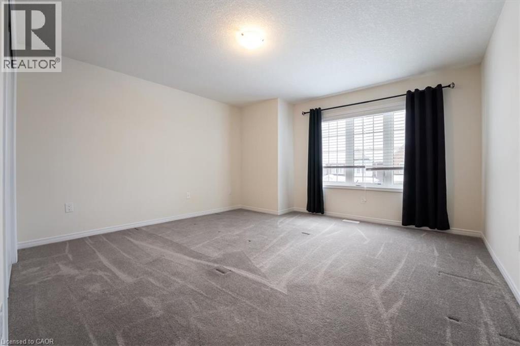 Carpeted empty room with a textured ceiling and baseboards - 13 Steven Drive, Thorold, ON - Indoor Photo Showing Other Room