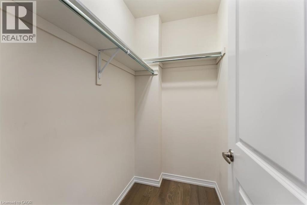 Walk in closet with dark wood-style floors - 13 Steven Drive, Thorold, ON - Indoor With Storage