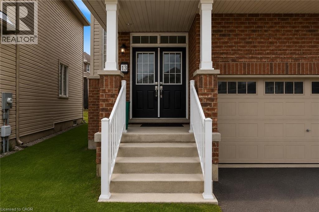 Brick facade with a covered porch featuring white columns and railings - 13 Steven Drive, Thorold, ON - Outdoor With Exterior