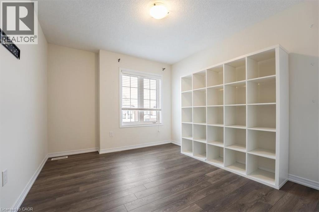 Unfurnished room with dark wood-style floors, a textured ceiling, and baseboards - 13 Steven Drive, Thorold, ON - Indoor Photo Showing Other Room