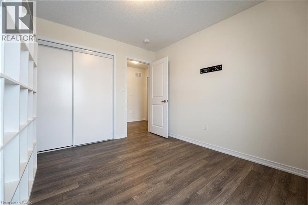 Unfurnished bedroom with a closet, dark wood finished floors, and baseboards - 13 Steven Drive, Thorold, ON - Indoor Photo Showing Other Room