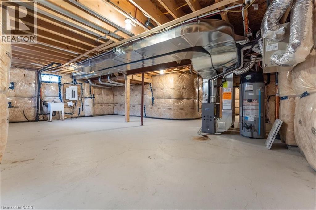 Unfinished below grade area featuring a sink, heating unit, electric panel, and gas water heater - 13 Steven Drive, Thorold, ON - Indoor Photo Showing Basement