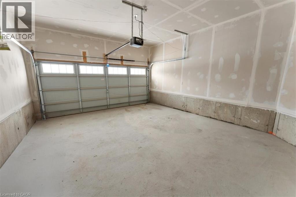 Garage with a garage door opener - 13 Steven Drive, Thorold, ON - Indoor Photo Showing Garage