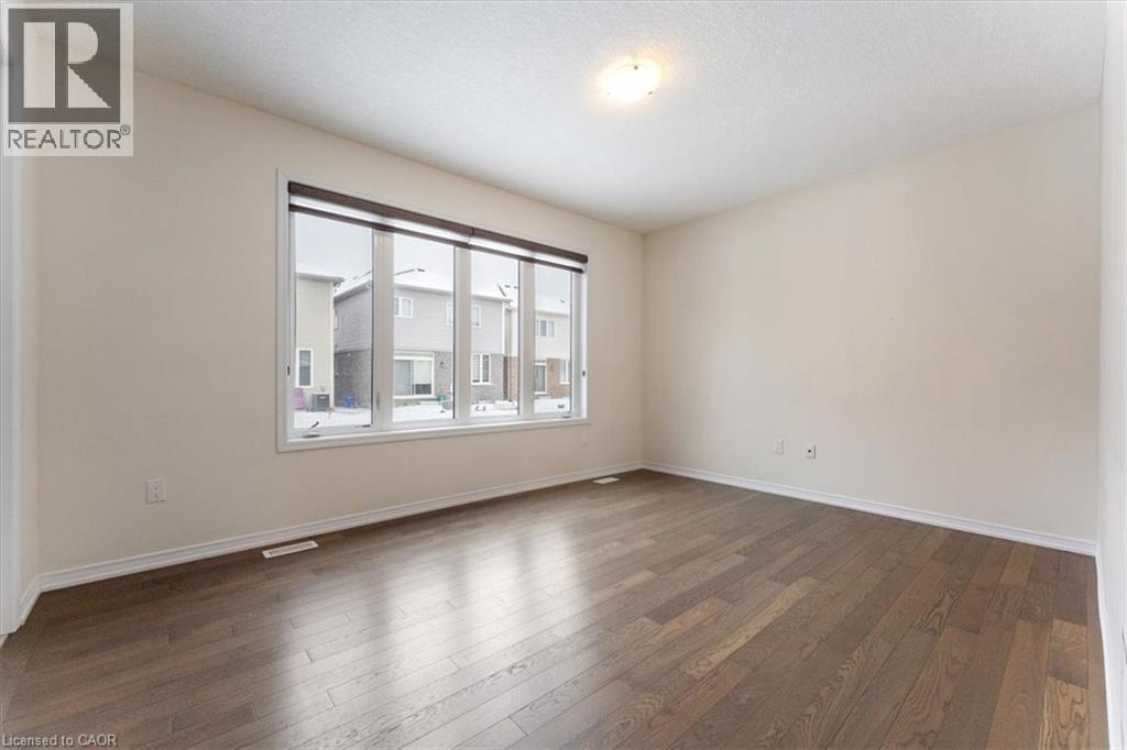 Spare room featuring dark wood-style floors, visible vents, and baseboards - 13 Steven Drive, Thorold, ON - Indoor Photo Showing Other Room