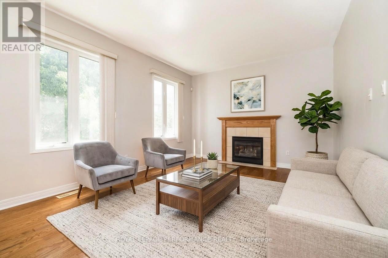 Family room off the kitchen *virtually styled - 127 Finn Court, Ottawa, ON - Indoor Photo Showing Living Room With Fireplace