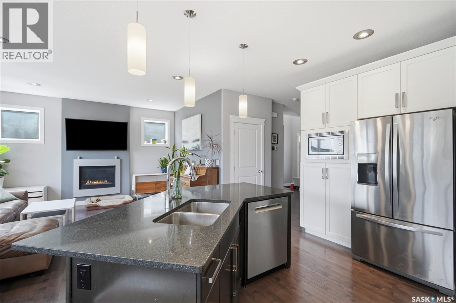 1115 Werschner Crescent, Saskatoon, SK - Indoor Photo Showing Kitchen With Fireplace With Double Sink With Upgraded Kitchen