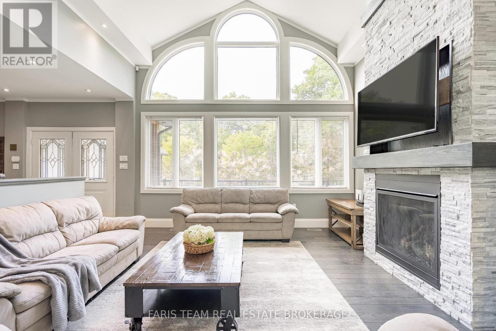 7 Duquette Court, Tiny, ON - Indoor Photo Showing Living Room With Fireplace