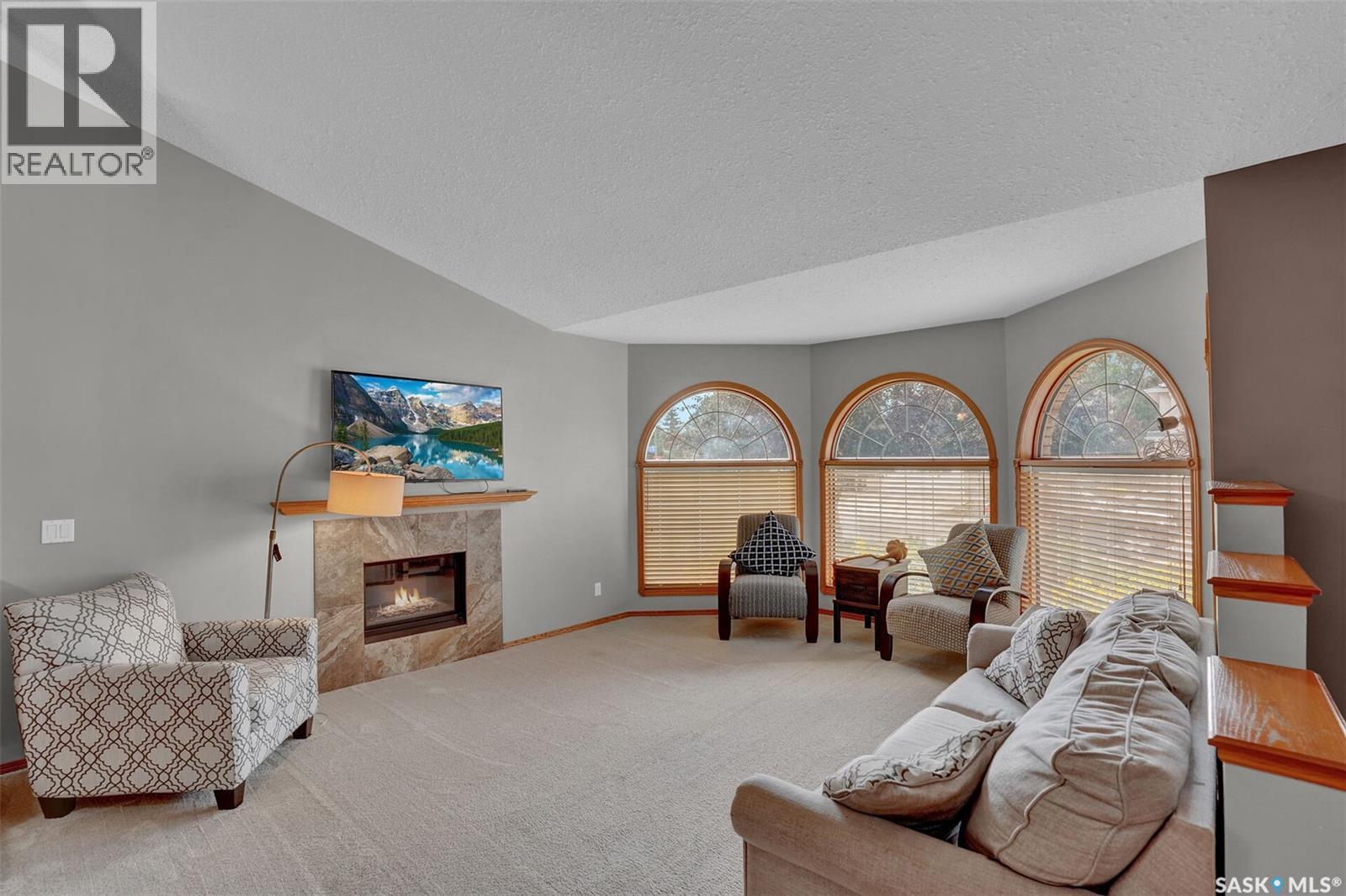 3210 Peyson Bay E, Regina, SK - Indoor Photo Showing Living Room With Fireplace