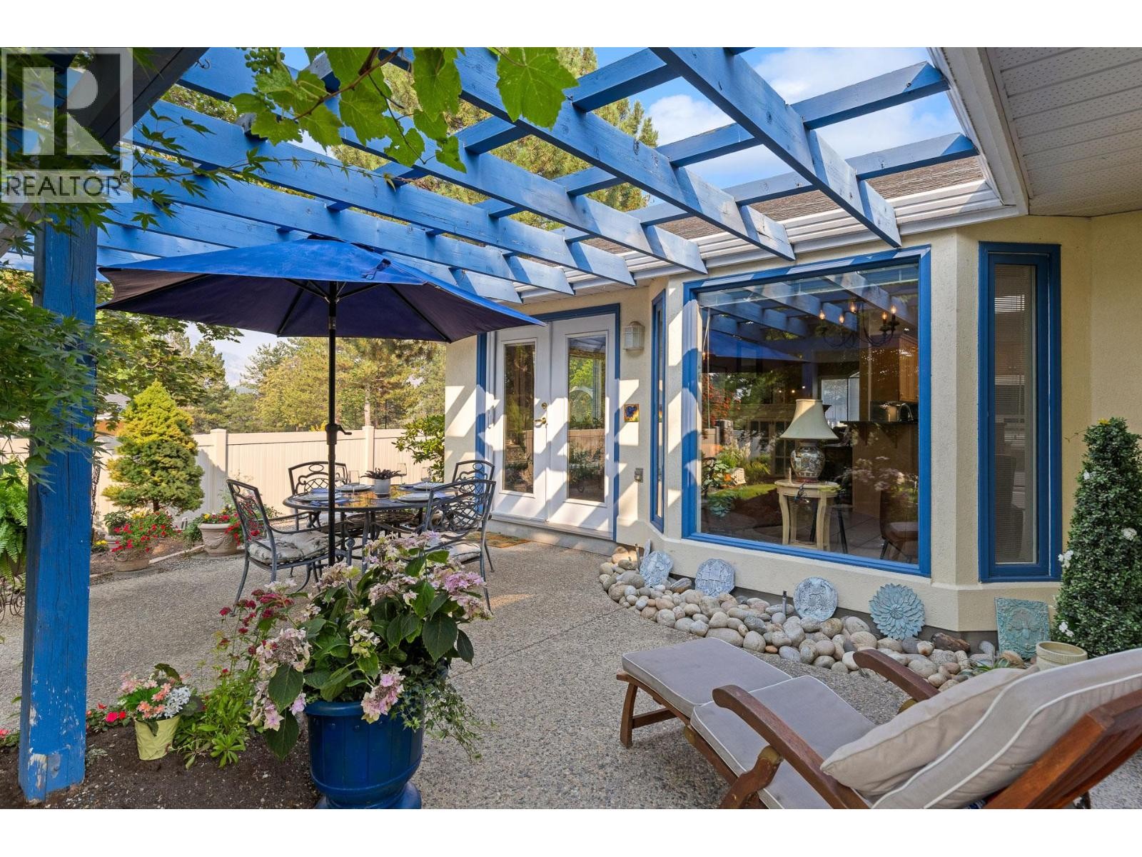 Deck view looking at kitchen & dining room. - 4000 Gallaghers Terrace, Kelowna, BC - Outdoor With Deck Patio Veranda