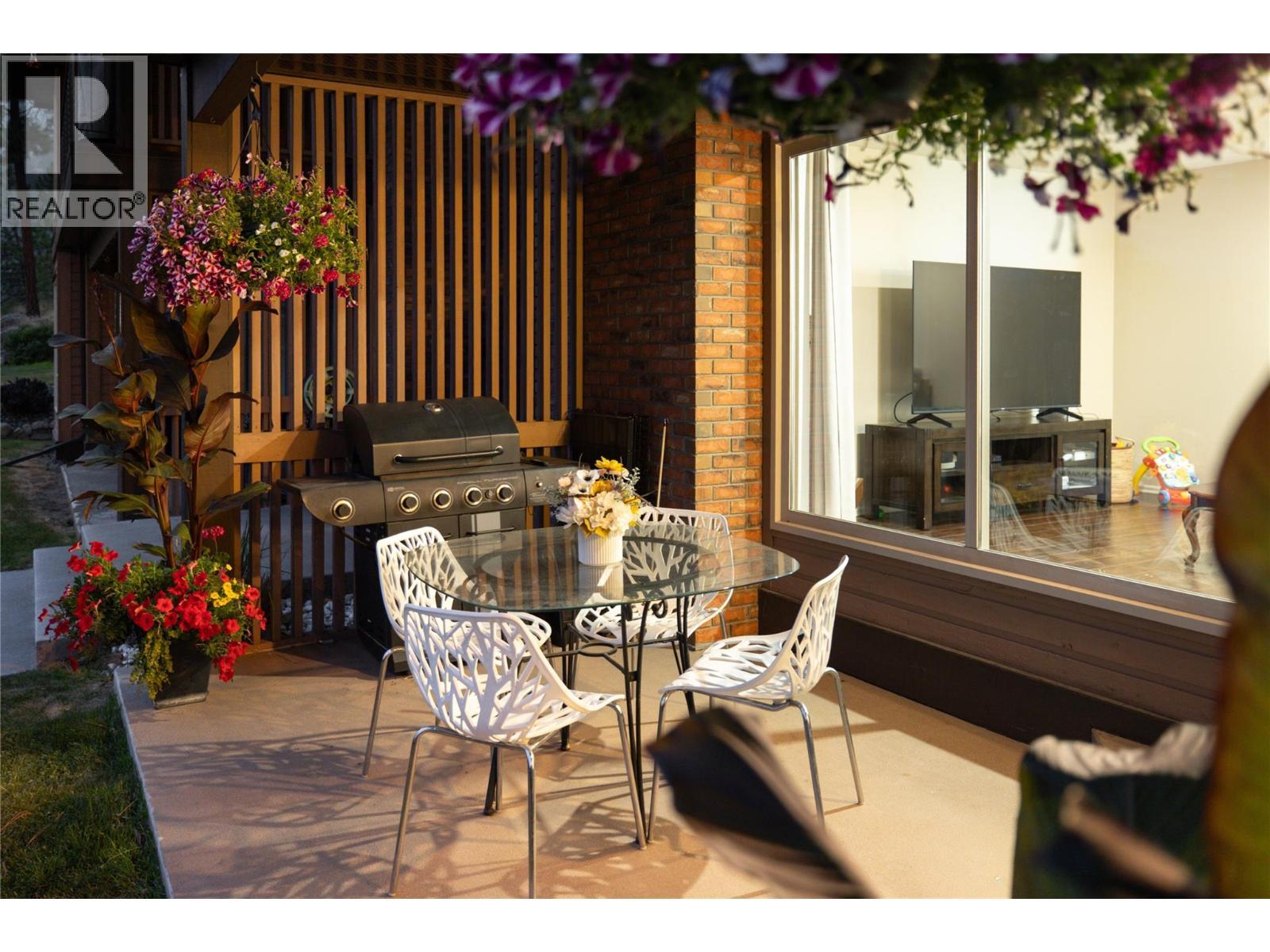 Twilight Patio View - 2226 Golf Course Drive, West Kelowna, BC - Photo Showing Dining Room